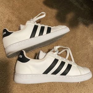 White adidas with black stripes